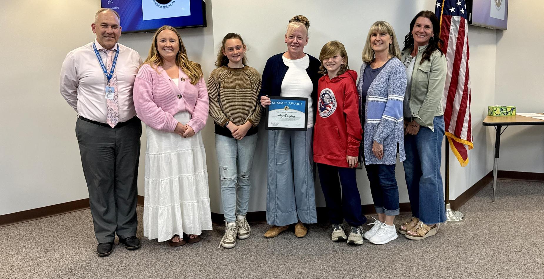 Group photo of May Summit Award winner Mary Dempsey with Summit Hill 161 staff and students after being recognized during the Board of Education meeting.