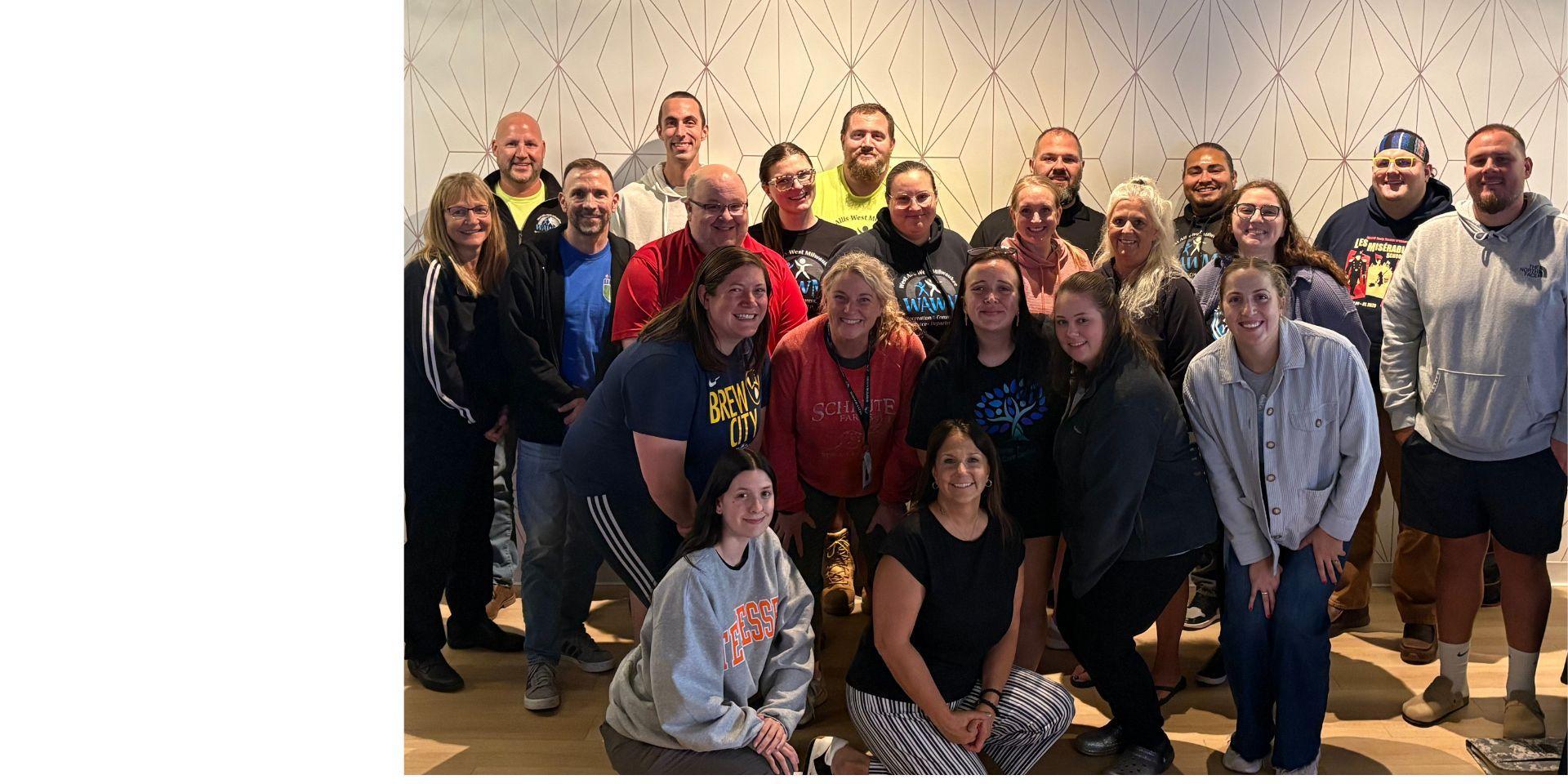 WAWM RCS Department full team photo at retreat in a well-lit room.