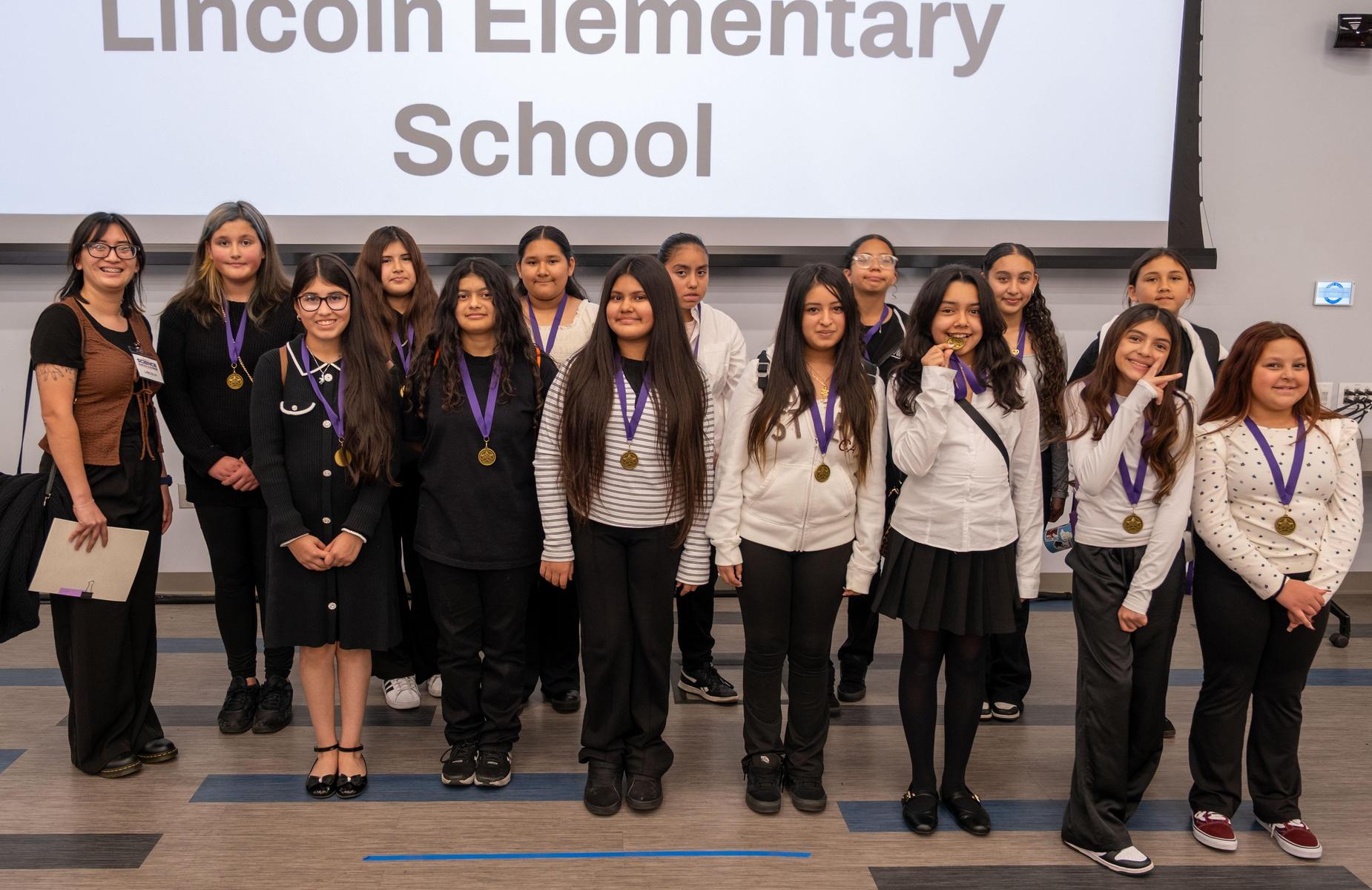 Lincoln group with medals about 13 students with 1 Judge