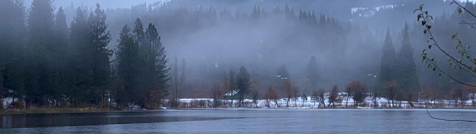 Cold lake with snow and fog
