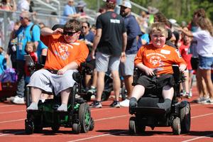 Two Penn Yan student-athletes participate in a track event using power wheelchairs.