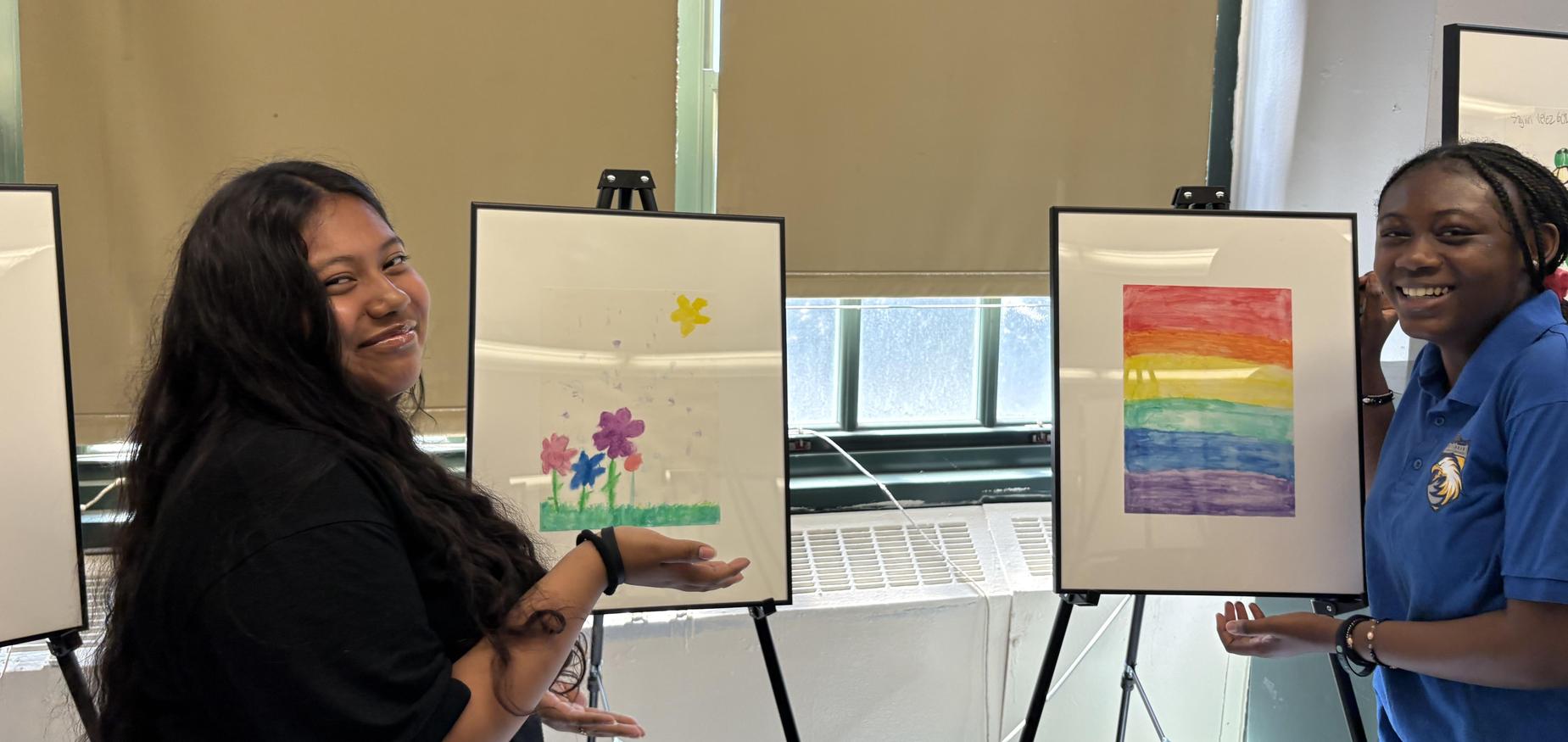 Two students standing in front of their artwork