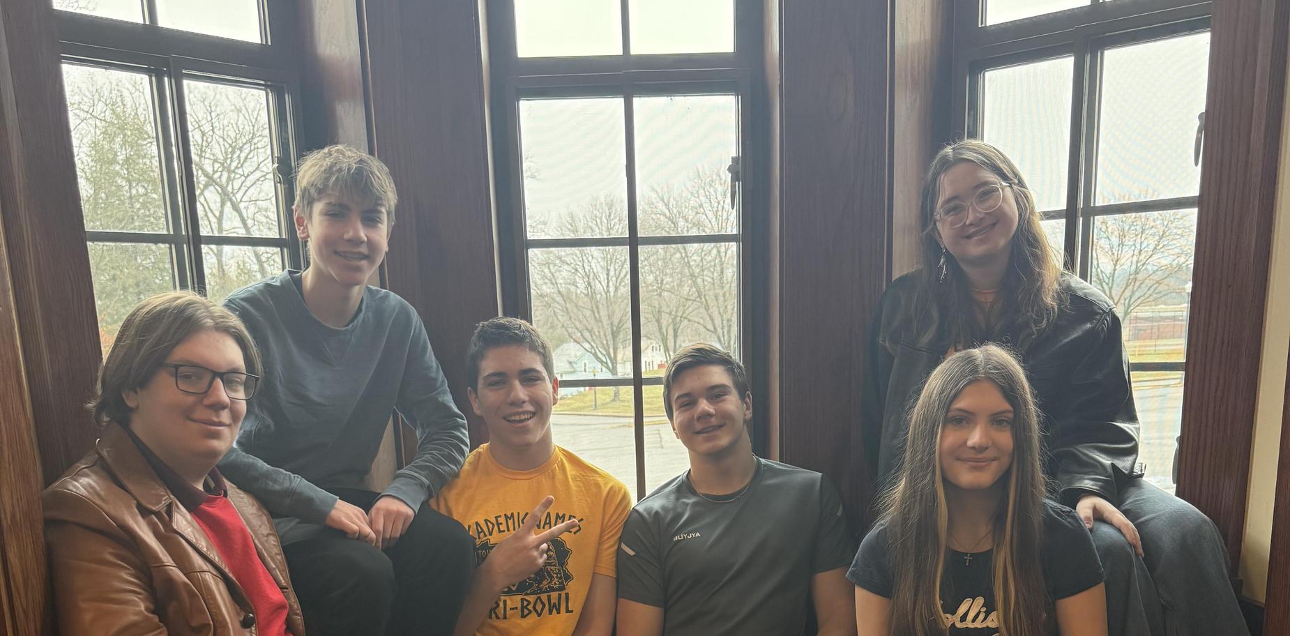 Group of teenagers sitting together in a cozy corner.