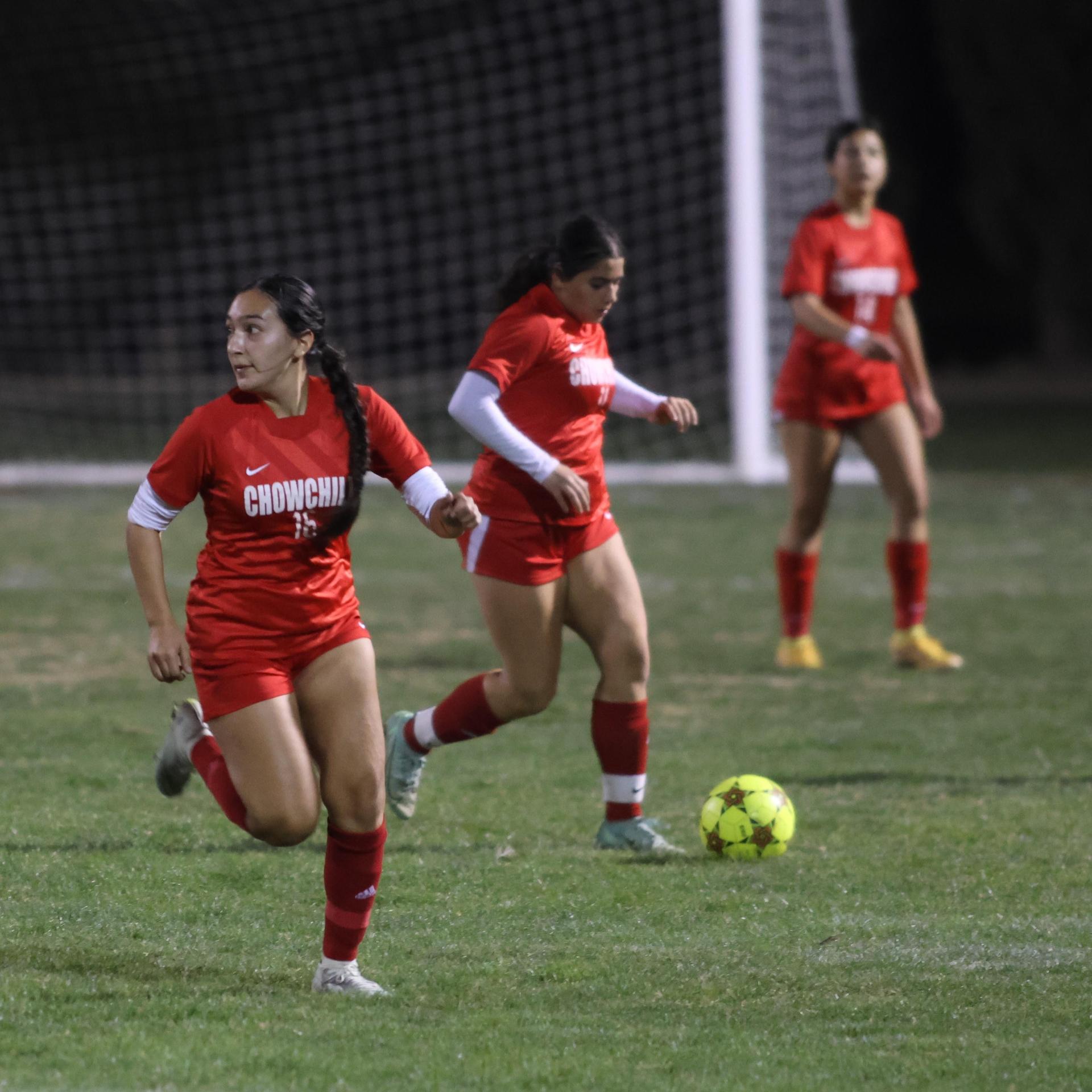 Varsity girls playing soccer against sunnyside