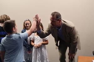 Superintendent Dr. Brown High-fives a student from Williams Elementary after the Pledge of Allegiance