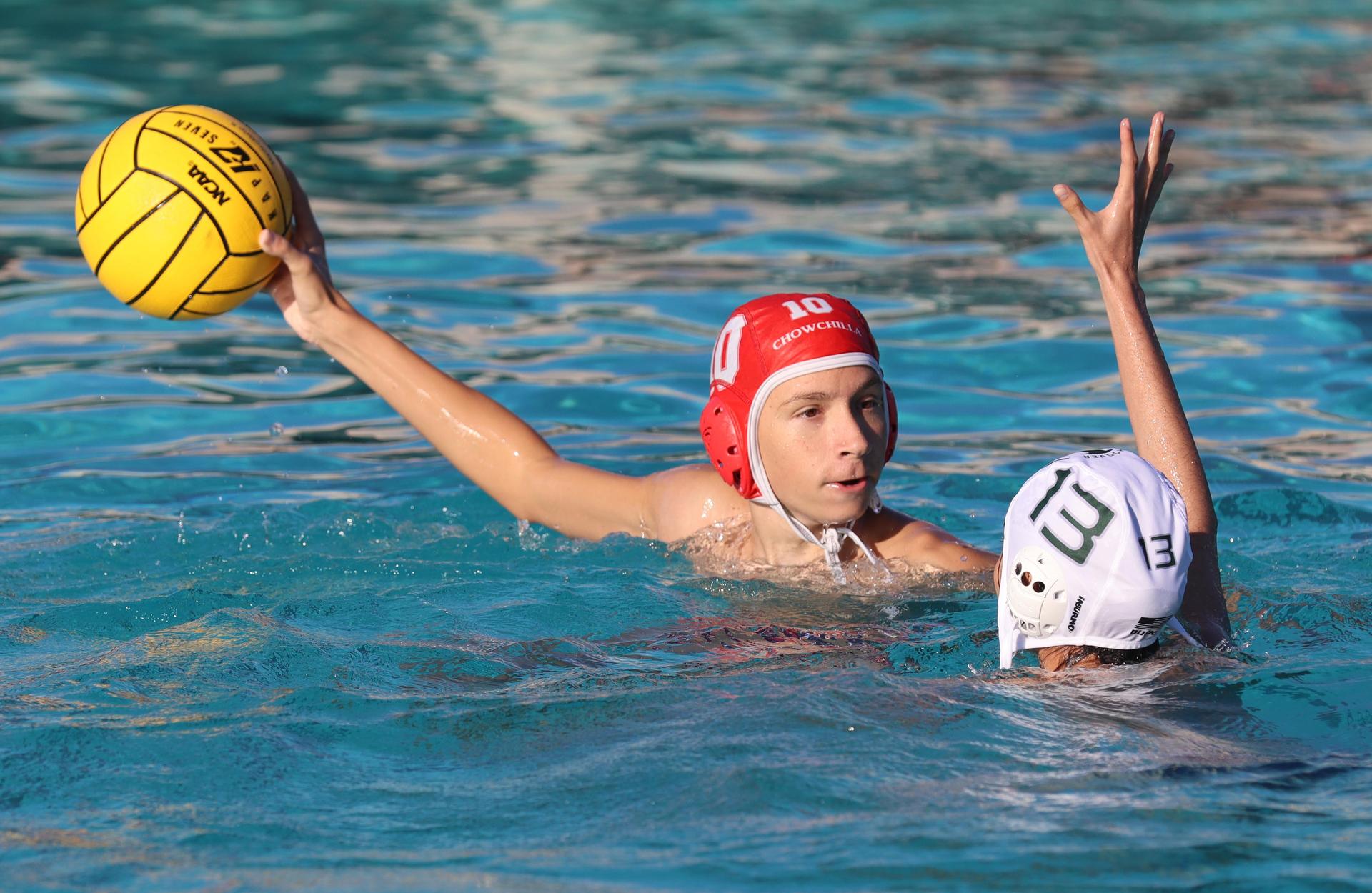 boys water polo players in action against hoover