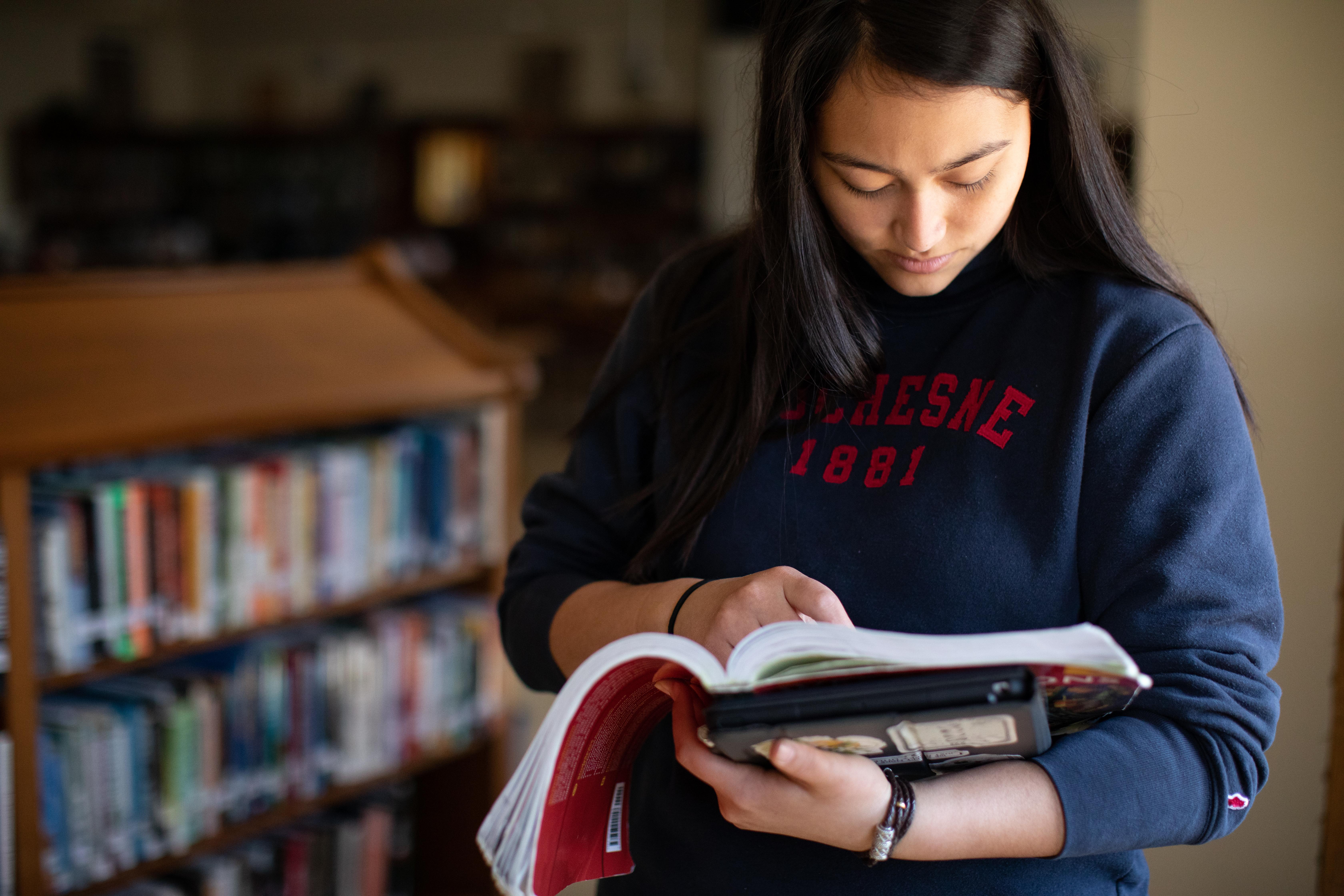 student reading in the library