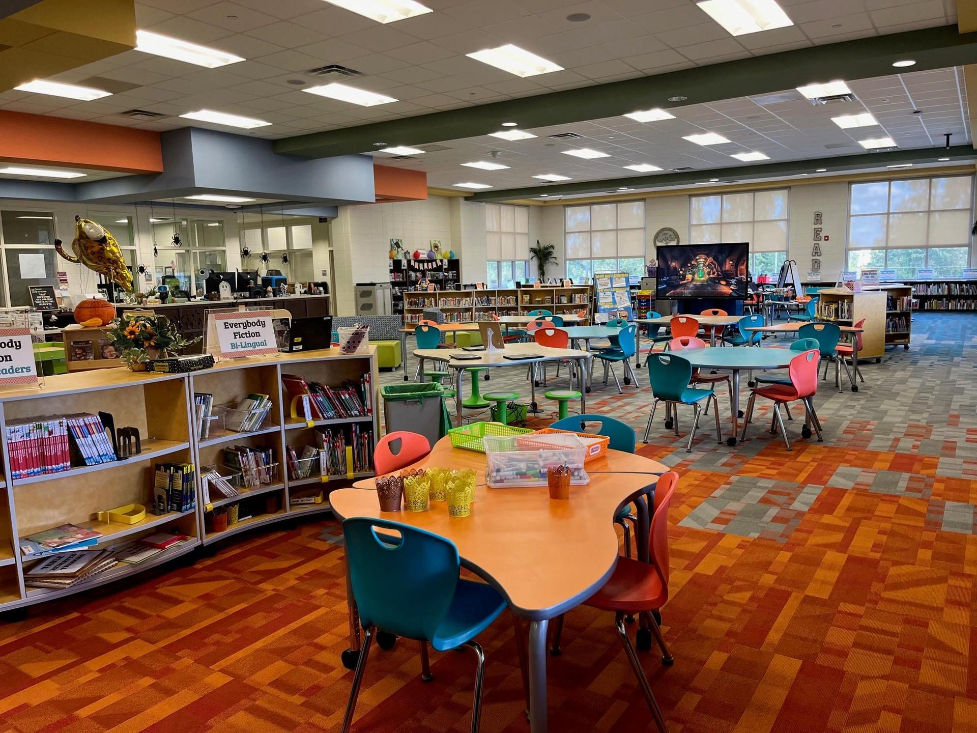 Grovetown Learning Commons space including tables, chairs, and shelves of books.