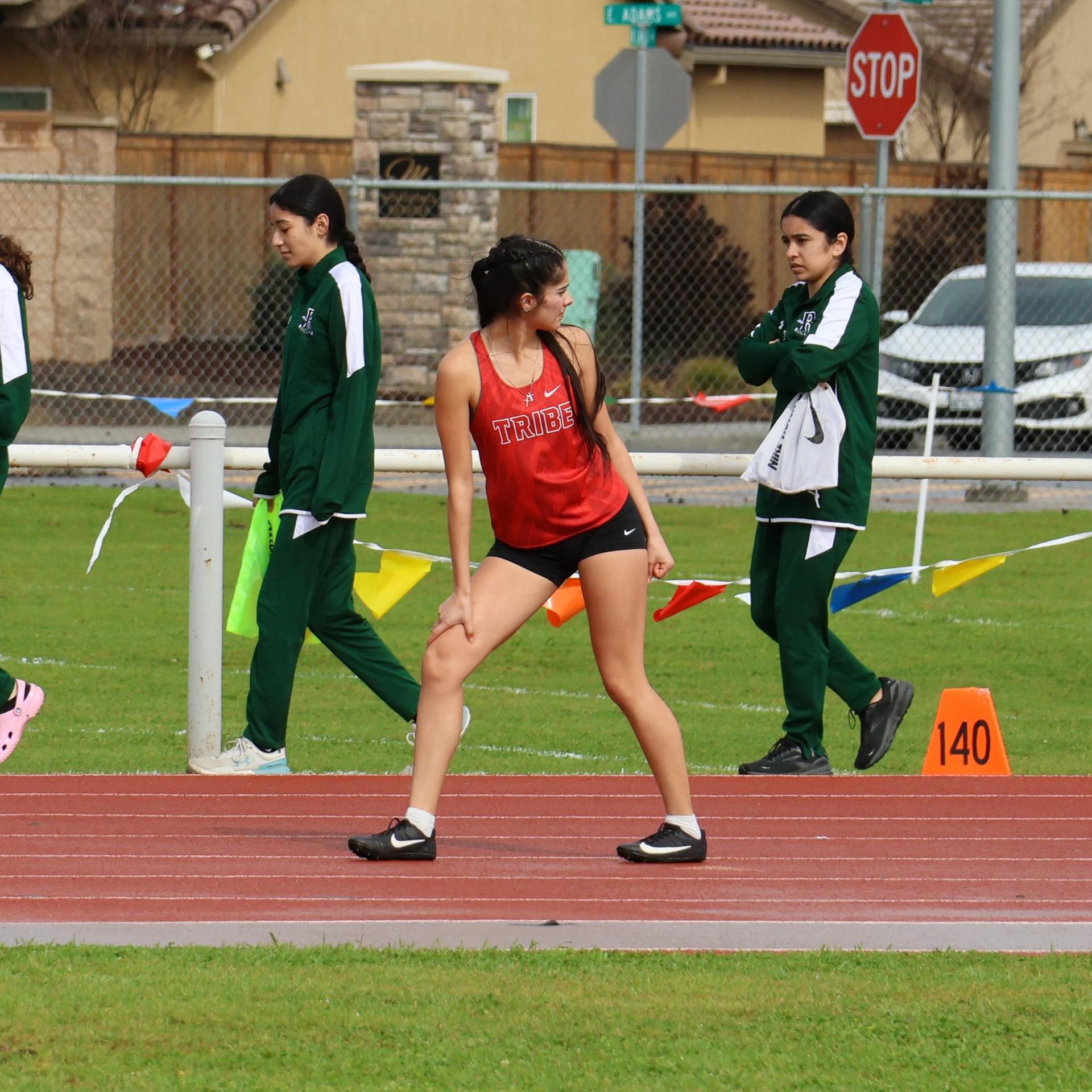 girls running the four by 100 meter relay