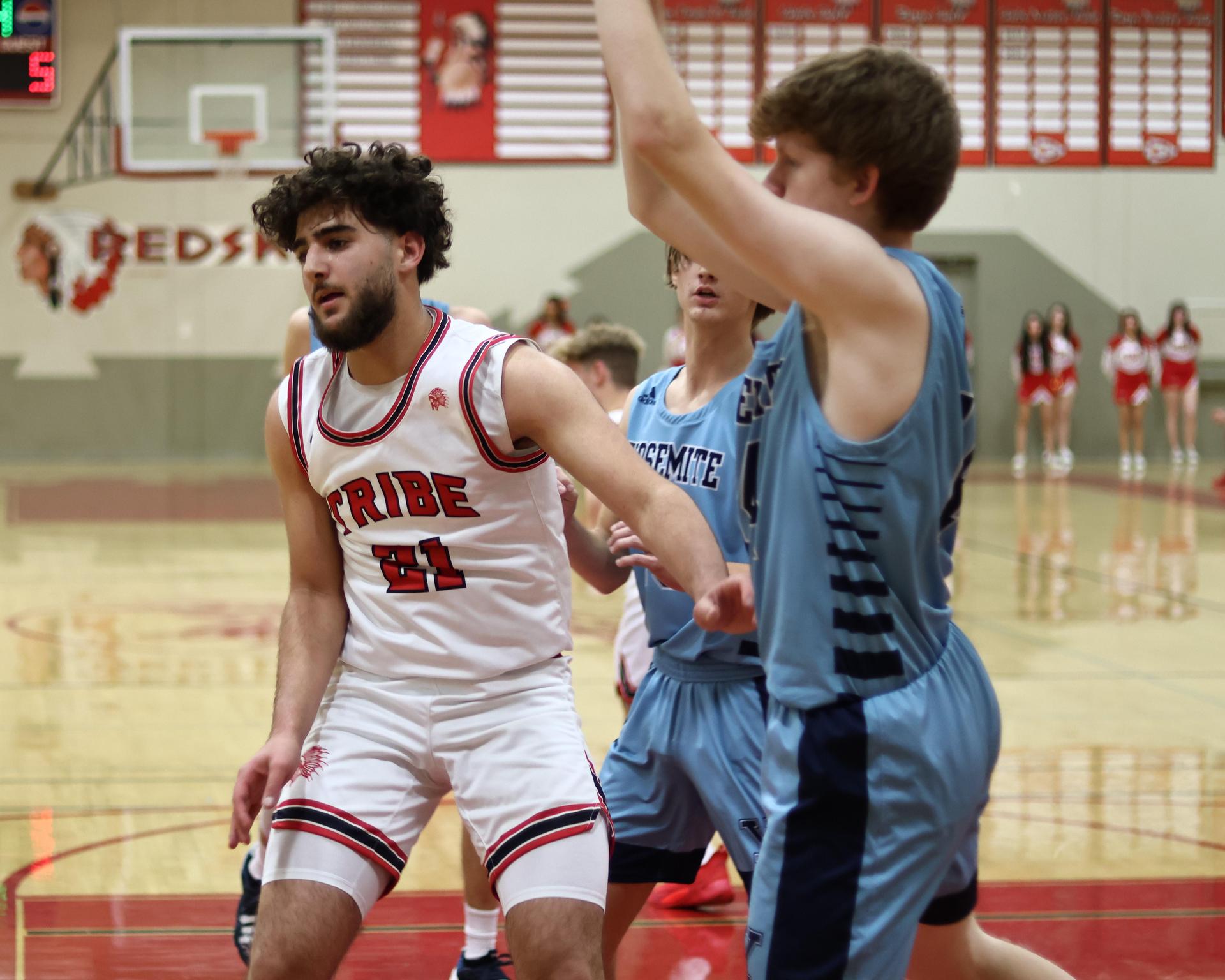 Varsity boys playing basketball against yosemite