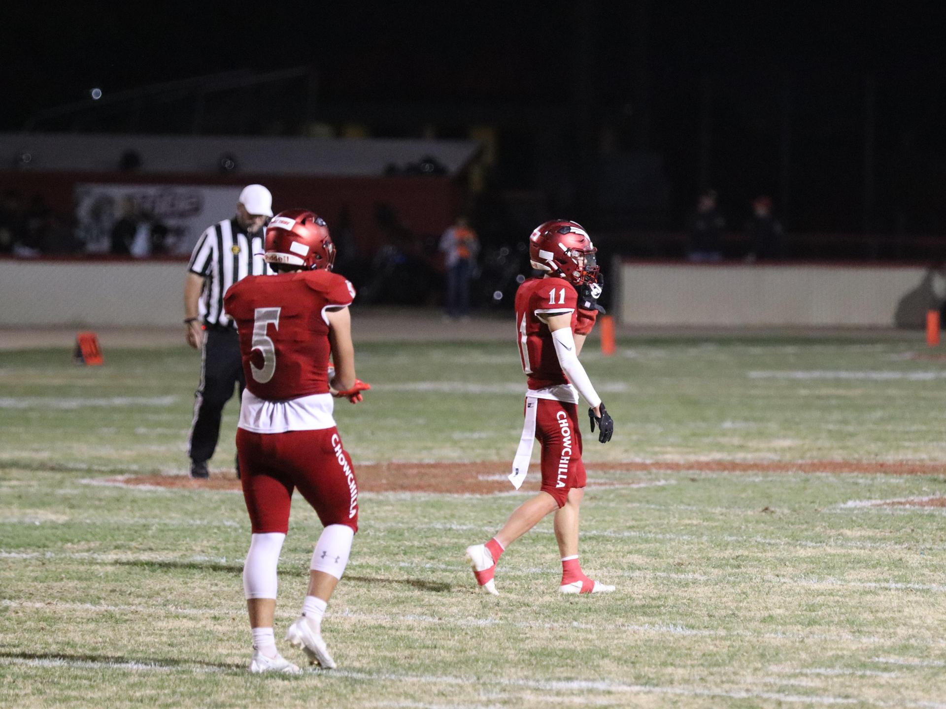 varsity football players in action against Riverdale