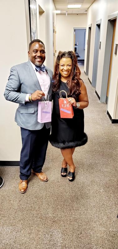 Dr. Pilot and Dr. Holmes holding a token of appreciation from the FCTC Faculty and Staff.