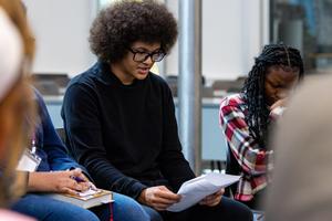 A male student reads a poem