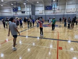 A mentor plays basketball with his mentee