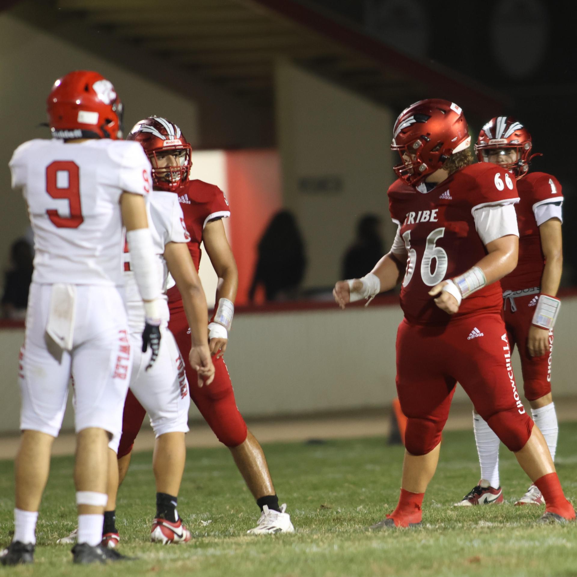 varsity boys playing football against Fowler