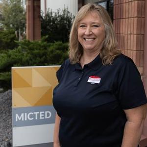 Transportation Director in front of MICTED sign