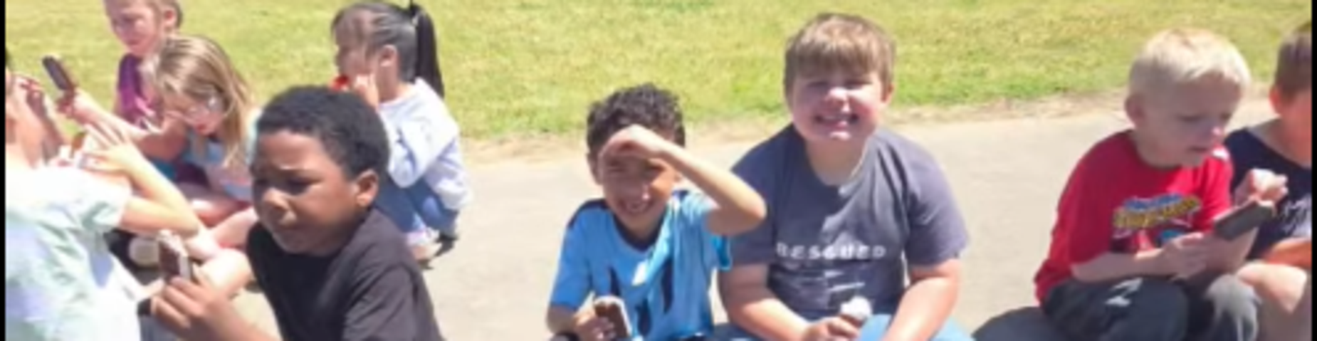 Students enjoying ice cream on a sunny day.