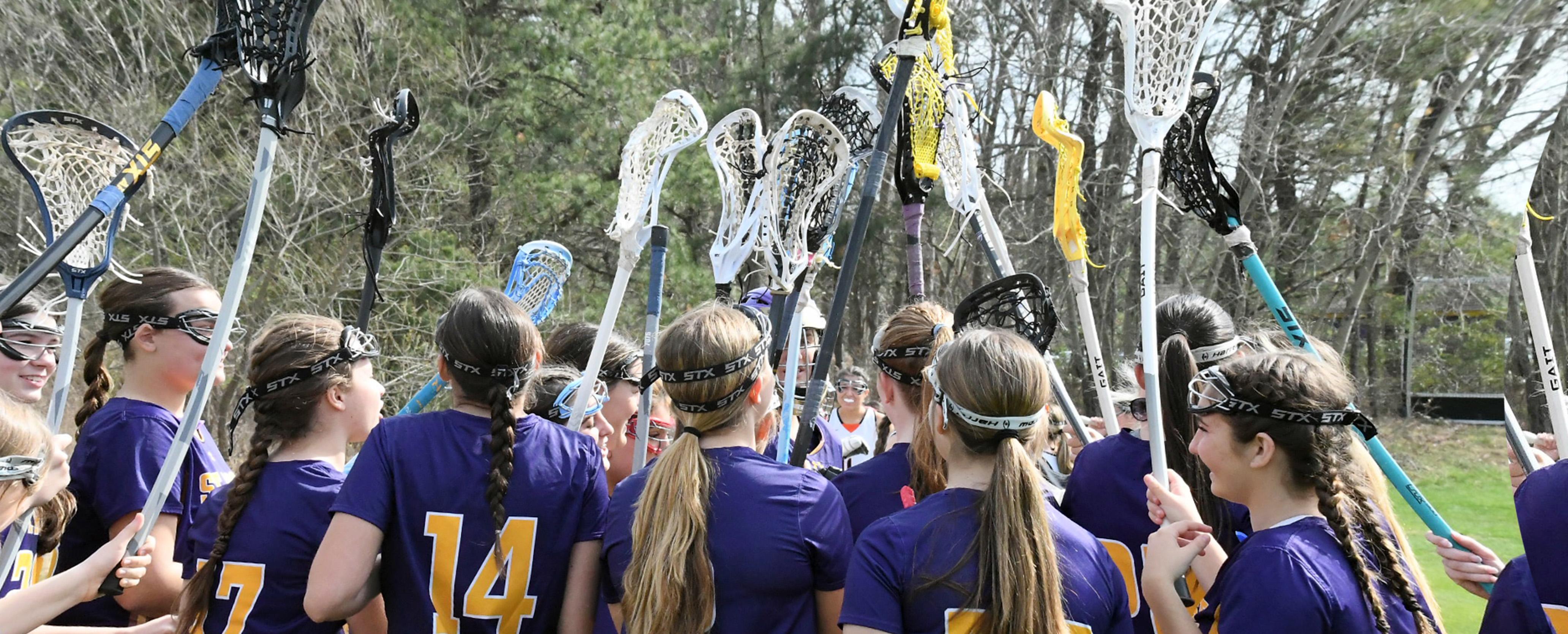 Field Hockey Holding up their Sticks