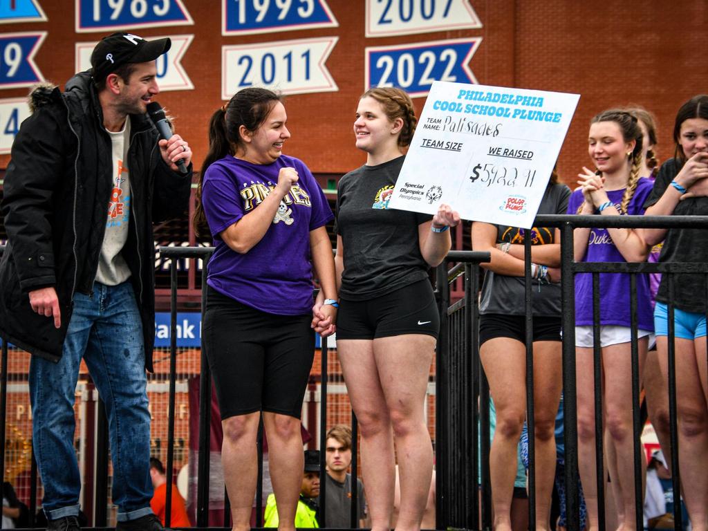 High school students holding up a sign showing the amount earned for the Special Olympics Polar Plunge in Philadelphia.