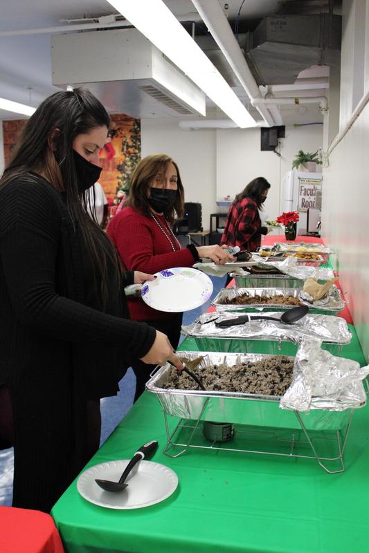 Women serving themselves food from platters