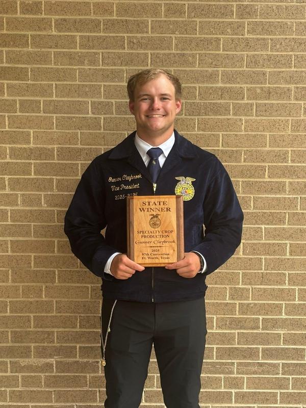 Gunner Claybrook posess with 1st place plaque at State FFA competition.