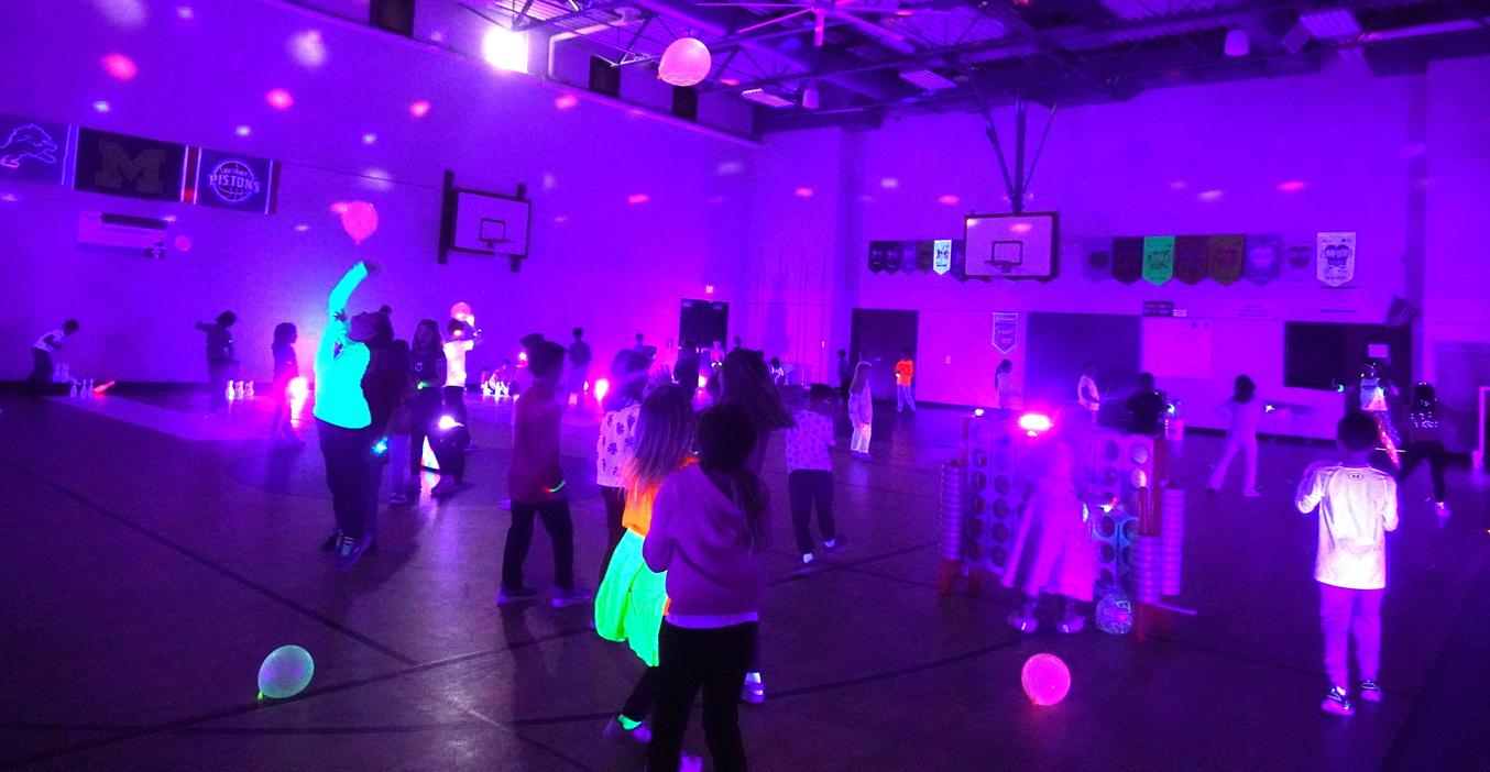 Students enjoy a glow party as a reward for positive behaviors.