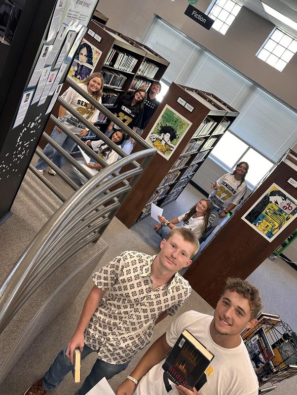 Lots of students in the stacks looking for a library book