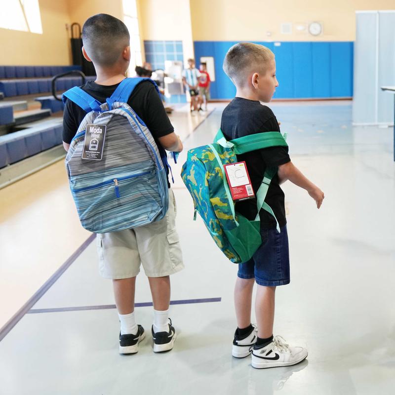 2 students with new backpacks