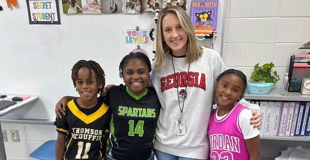Teacher and three students dressed up for Team Day on Red Ribbon