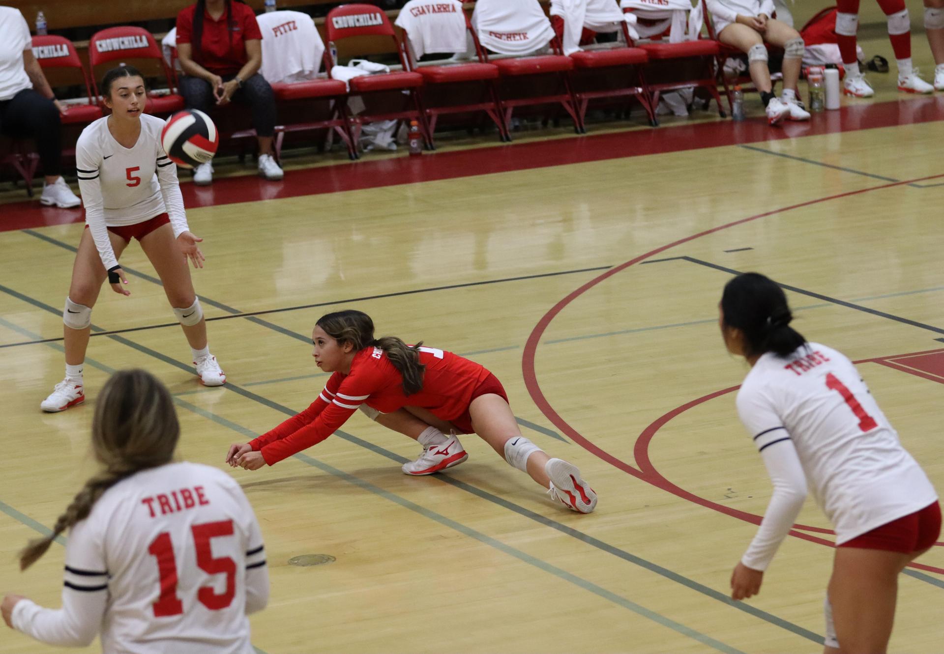 varsity volleyball players in action against liberty