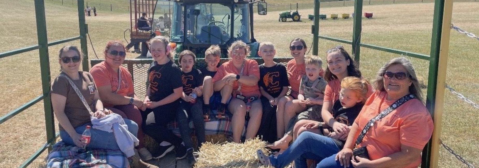 AIMS students and teachers take a hayride on the field trip to Richdale Farms.