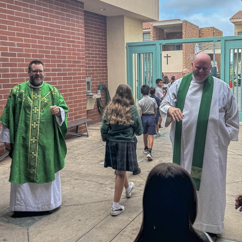Students exiting mass greeted by Fr. Matt and Fr. Jonathan