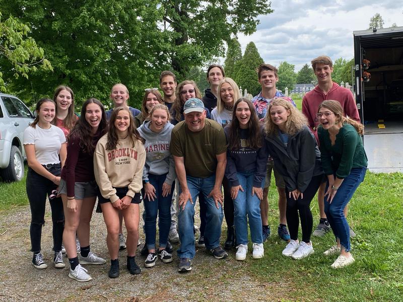 pic of students and a teacher at cemetery