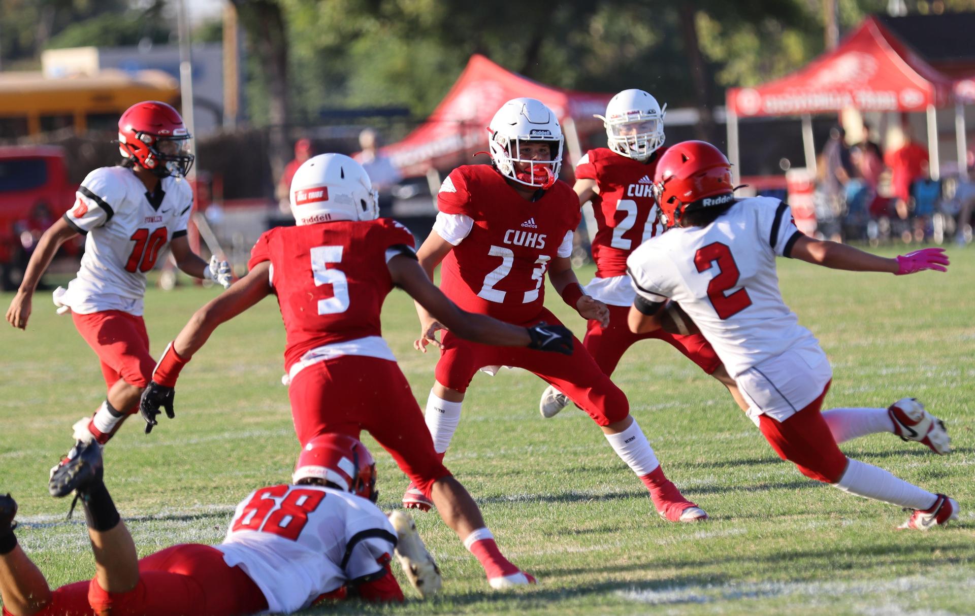 junior varsity football players in action against Fowler