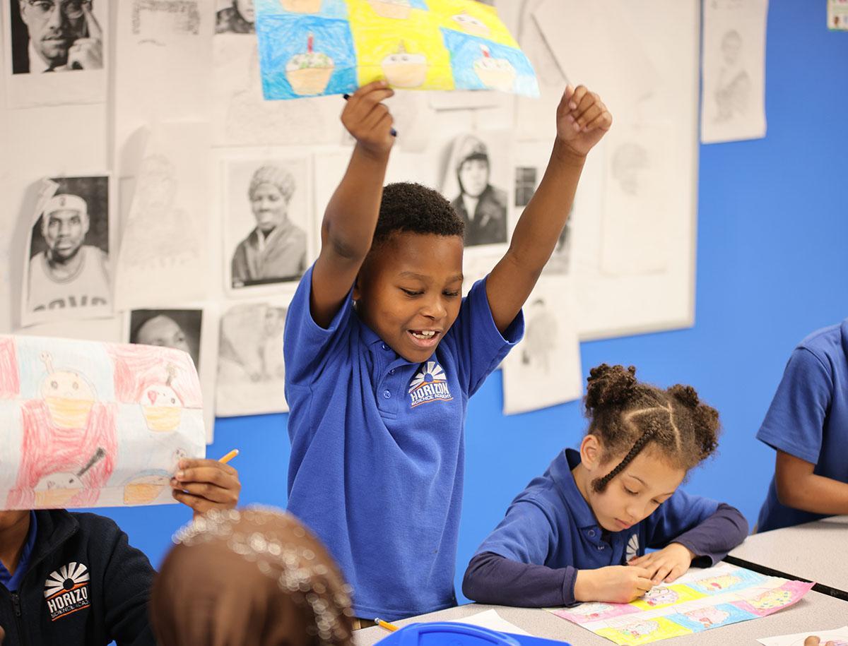 Horizon Science Academy Dayton Elementary Teacher and student interacting at a classroom desk