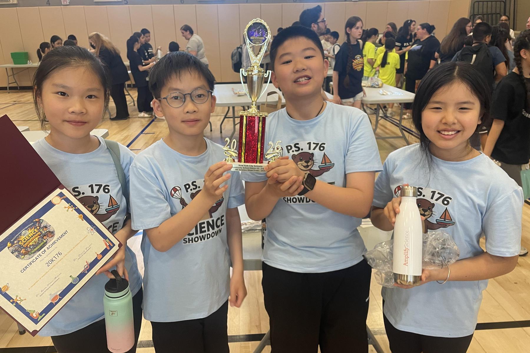 Group of students holding a trophy and certificate, smiling.