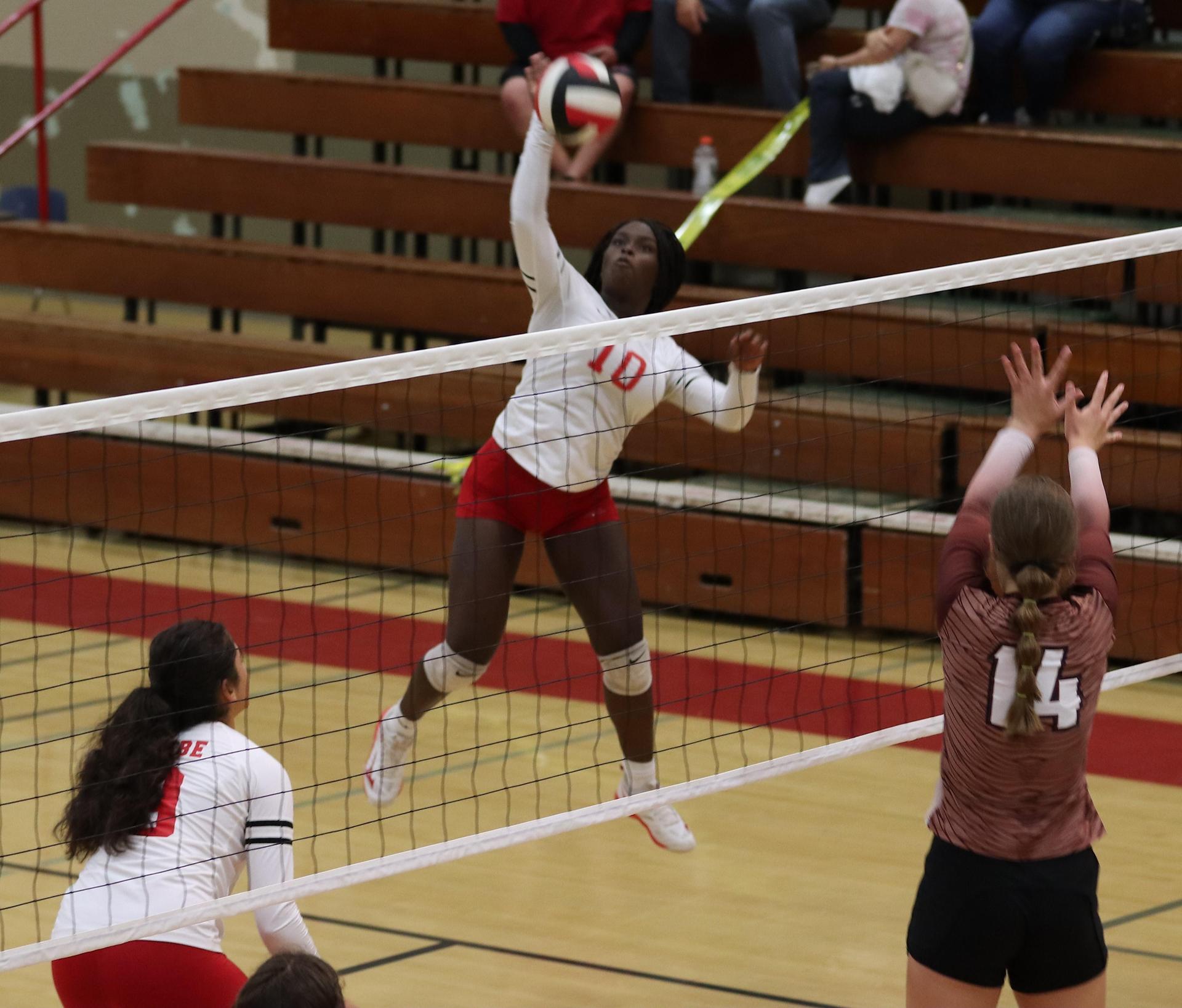varsity volleyball players in action against Fresno Christian