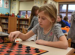 Students playing checkers