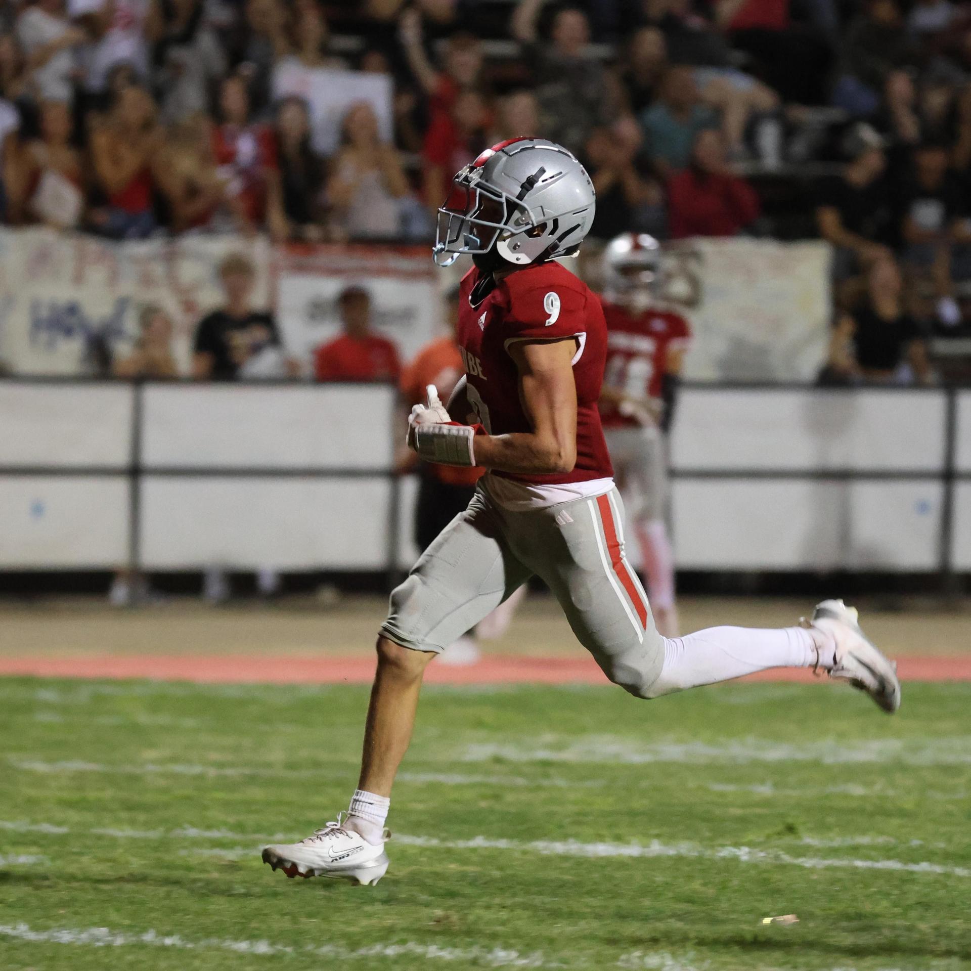 Varsity football players in action against Parlier 53