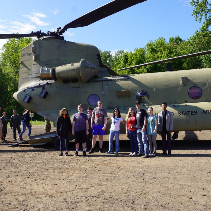 group of students in front of Chinnok helicopter