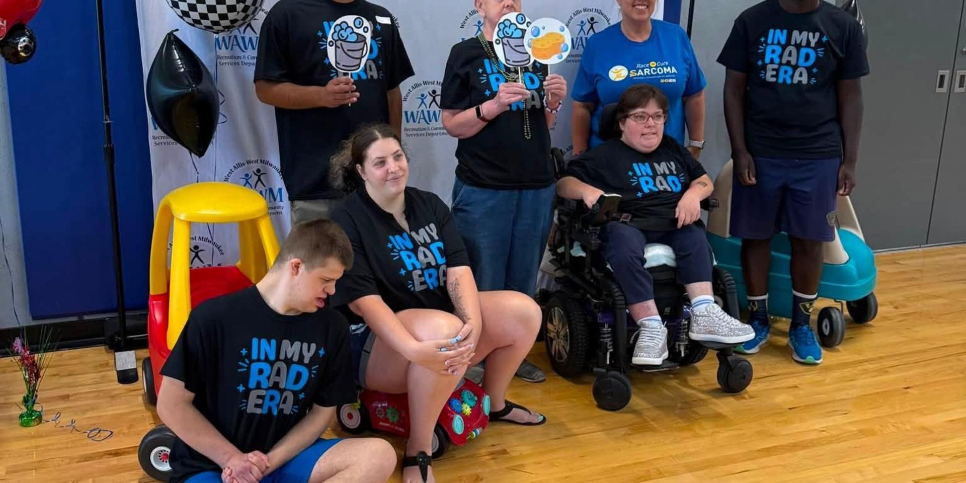 A group of individuals posing with playful props at an event.