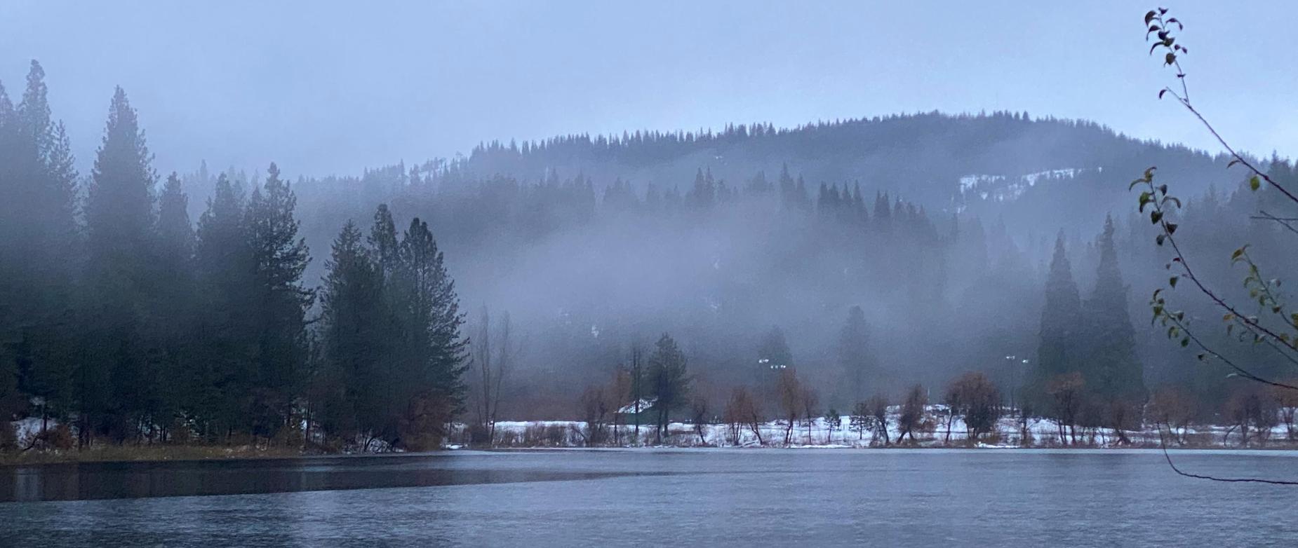Cold lake with snow and fog