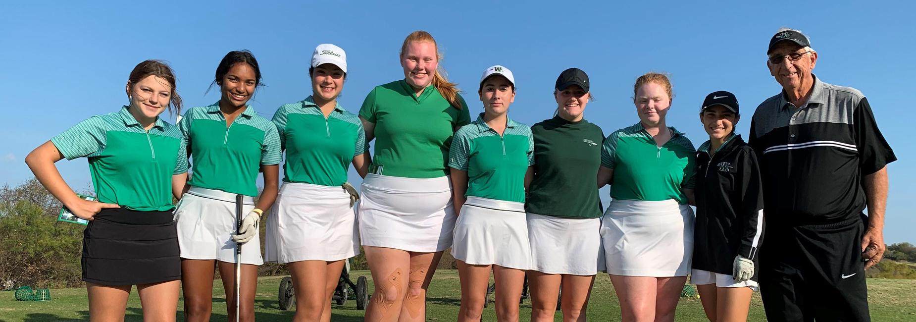 girls golf team and coach on the course