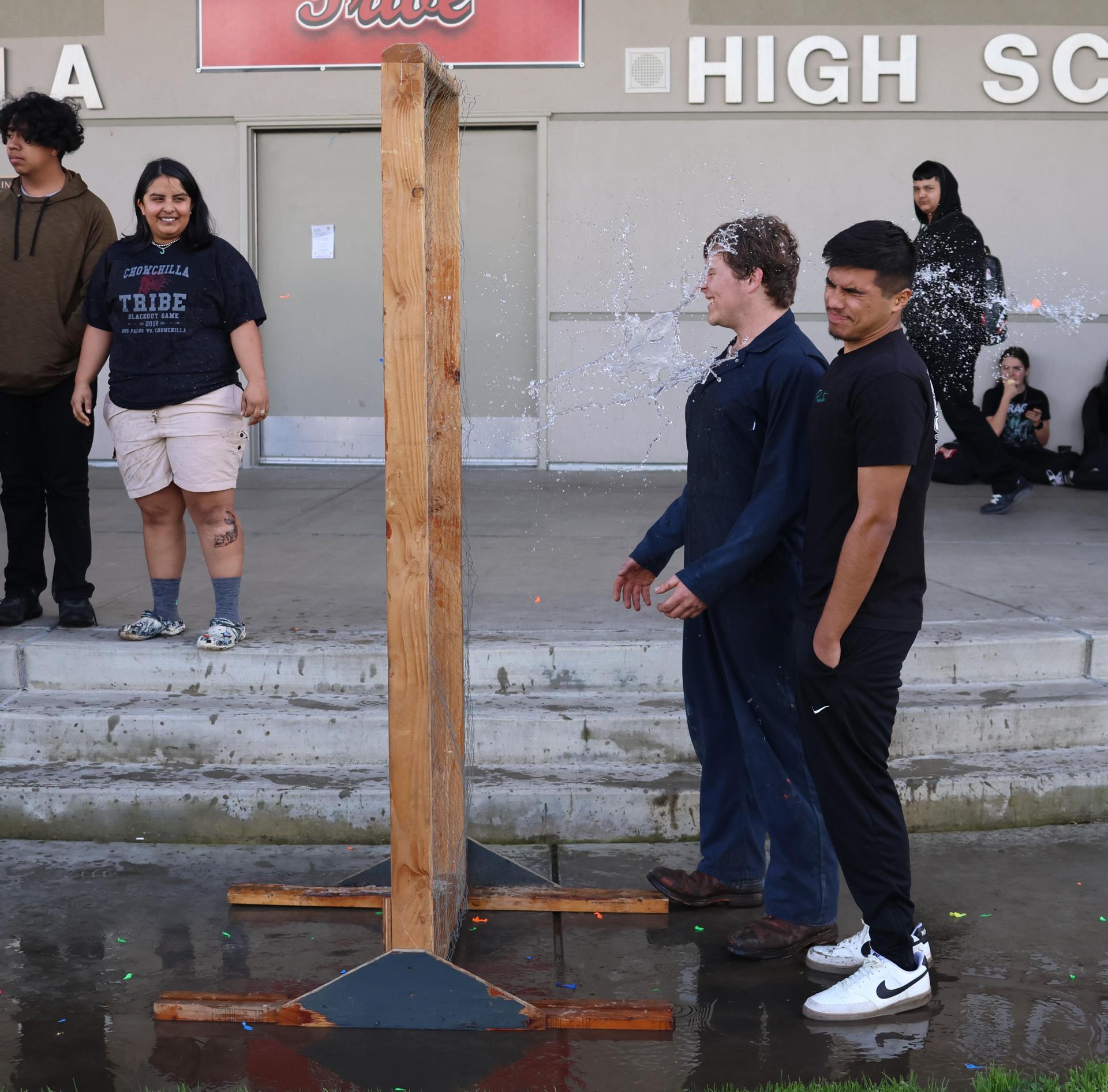 students and staff enjoying the water balloon toss
