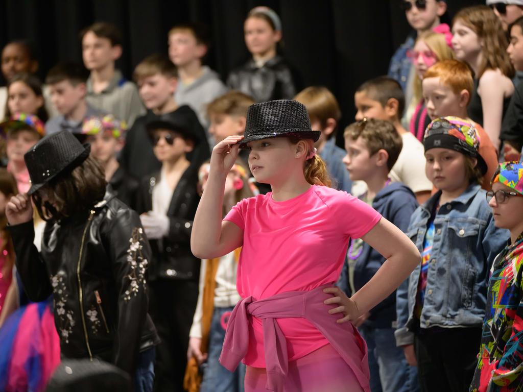 Students dressed in costumes performing.