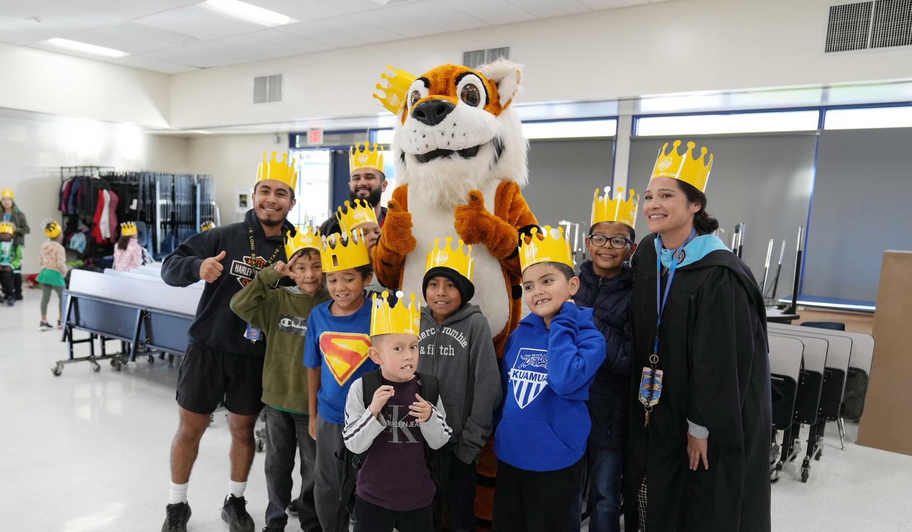 Student and mascot at De Anza wearing College Kick Off crowns