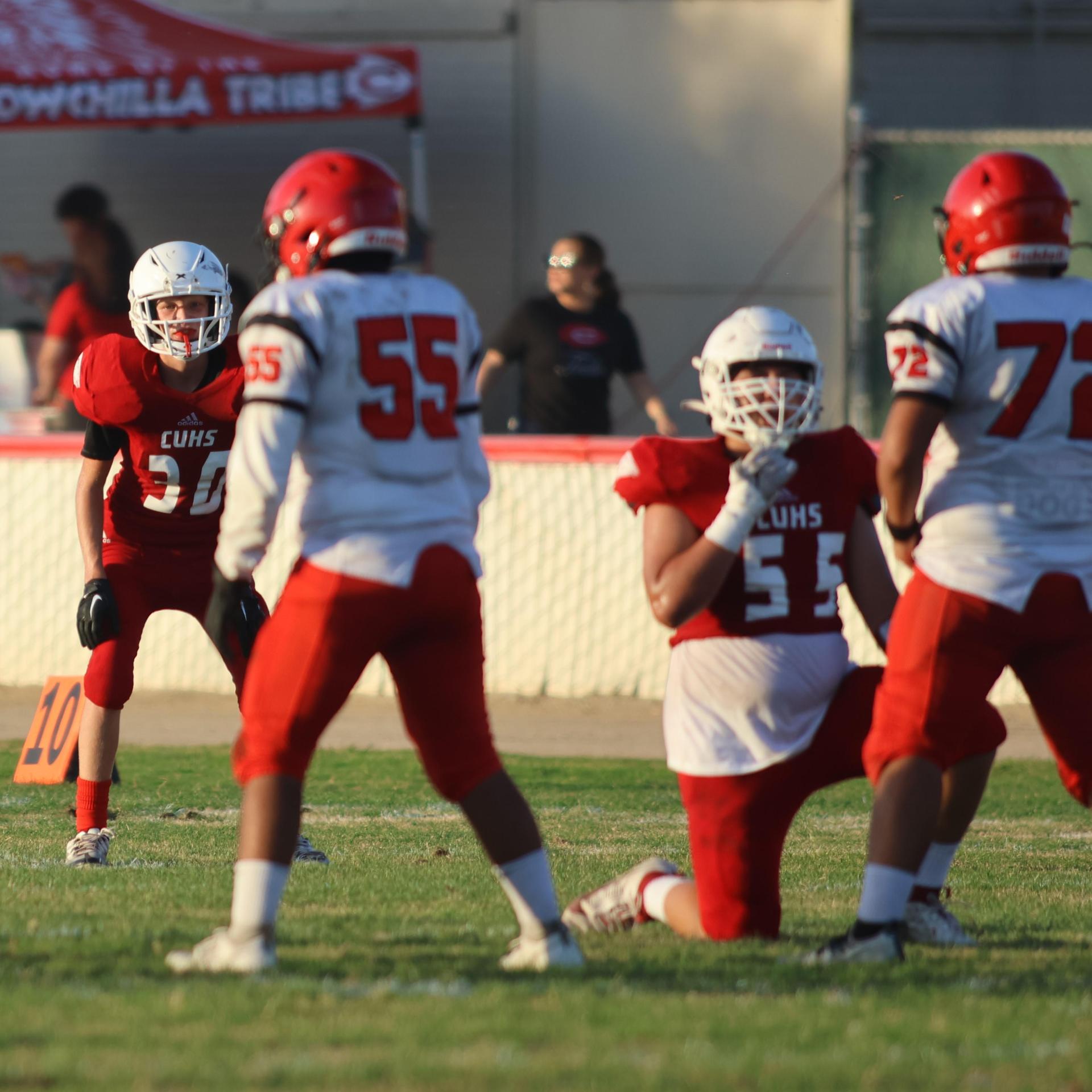 junior varsity football players in action against Fowler