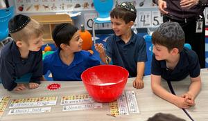 a group of kindergarten boys make pumpkin muffins