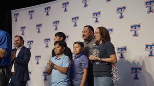 Jessica Cuellar stands with her family after being awarded Secondary Teacher of the Year