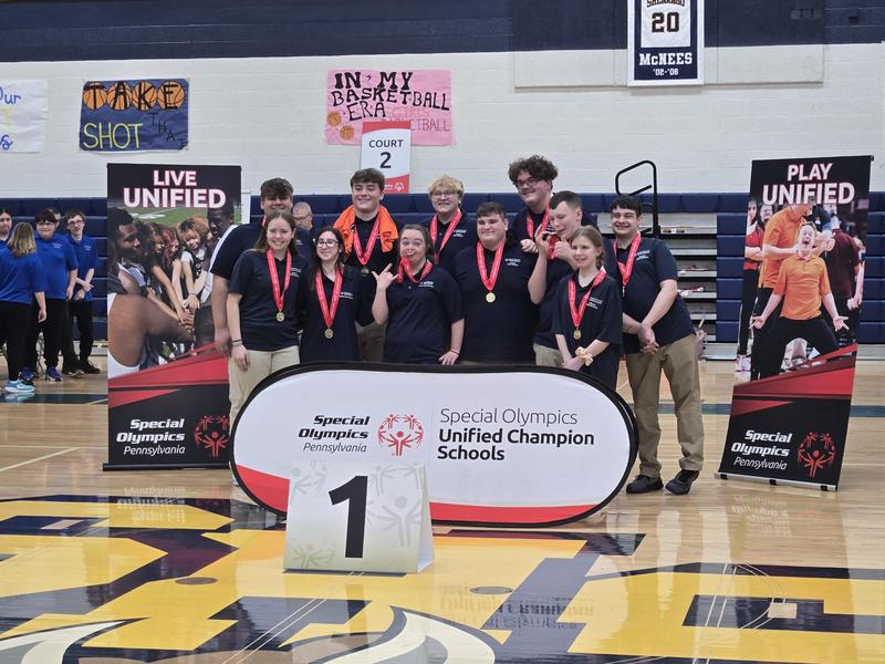 bocce team players with medals around neck and bocce signs around them